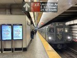 An early afternoon trip of the holiday train is about to depart Lexington Av-63 St Station.